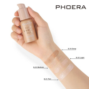 Hand holding a Phoera foundation bottle with four swatch shades on the forearm labeled G.01 Fair, G.02 Light, G.03 Medium, G.04 Deep.
